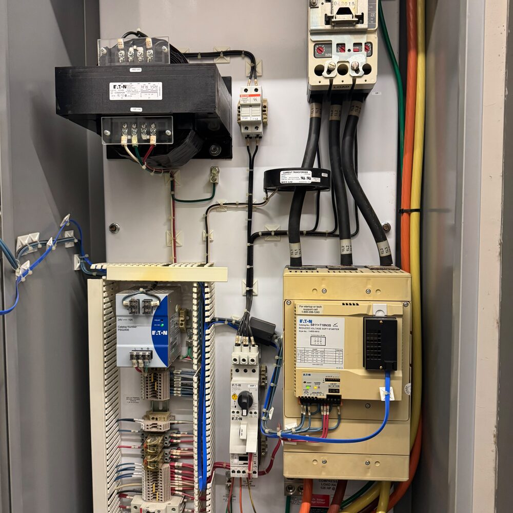 Control panel interior with reduced voltage soft starter for a 125 HP compressor